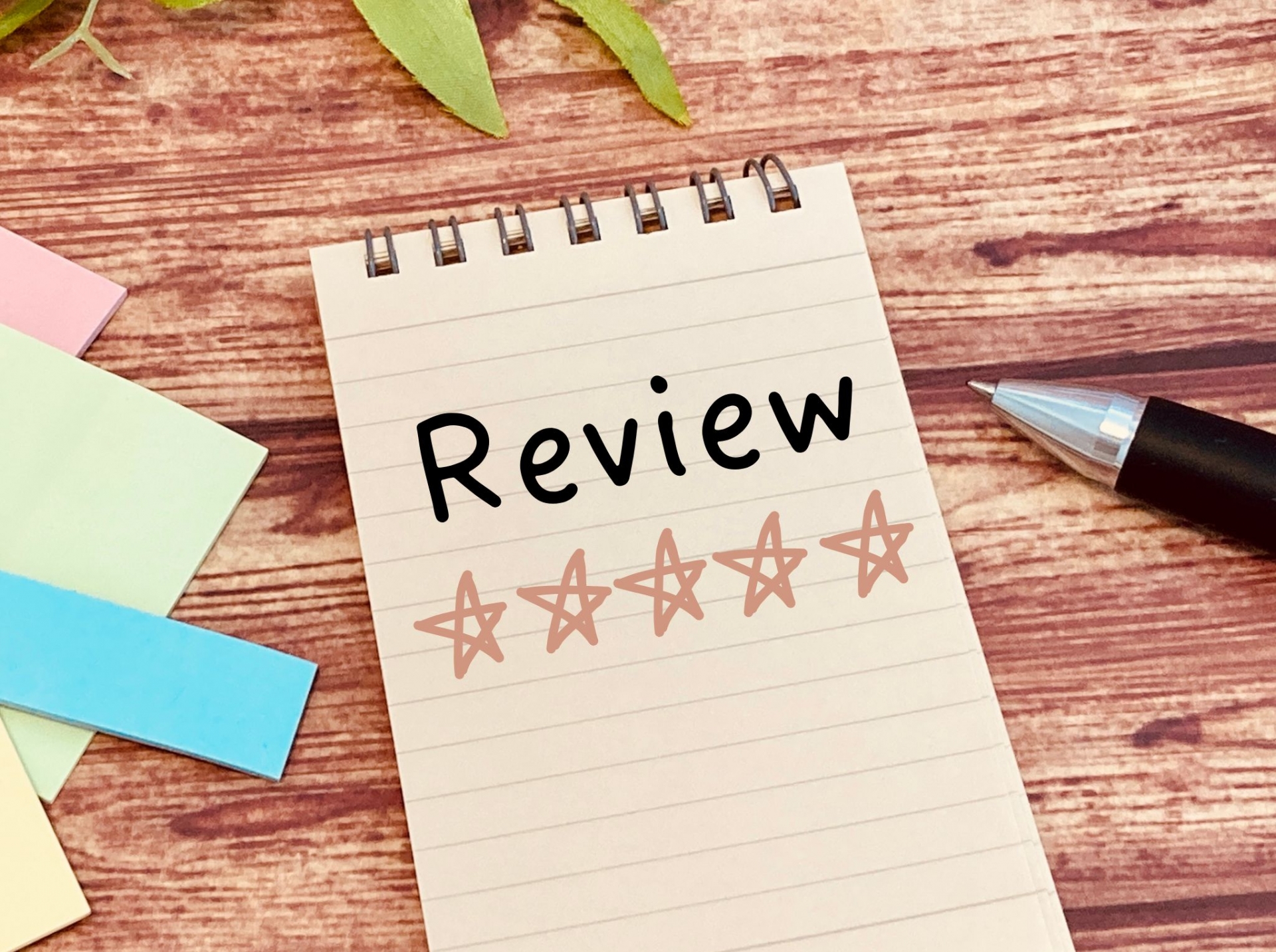 ノートに「Review」と書かれ、その下に5つの星の評価が描かれている